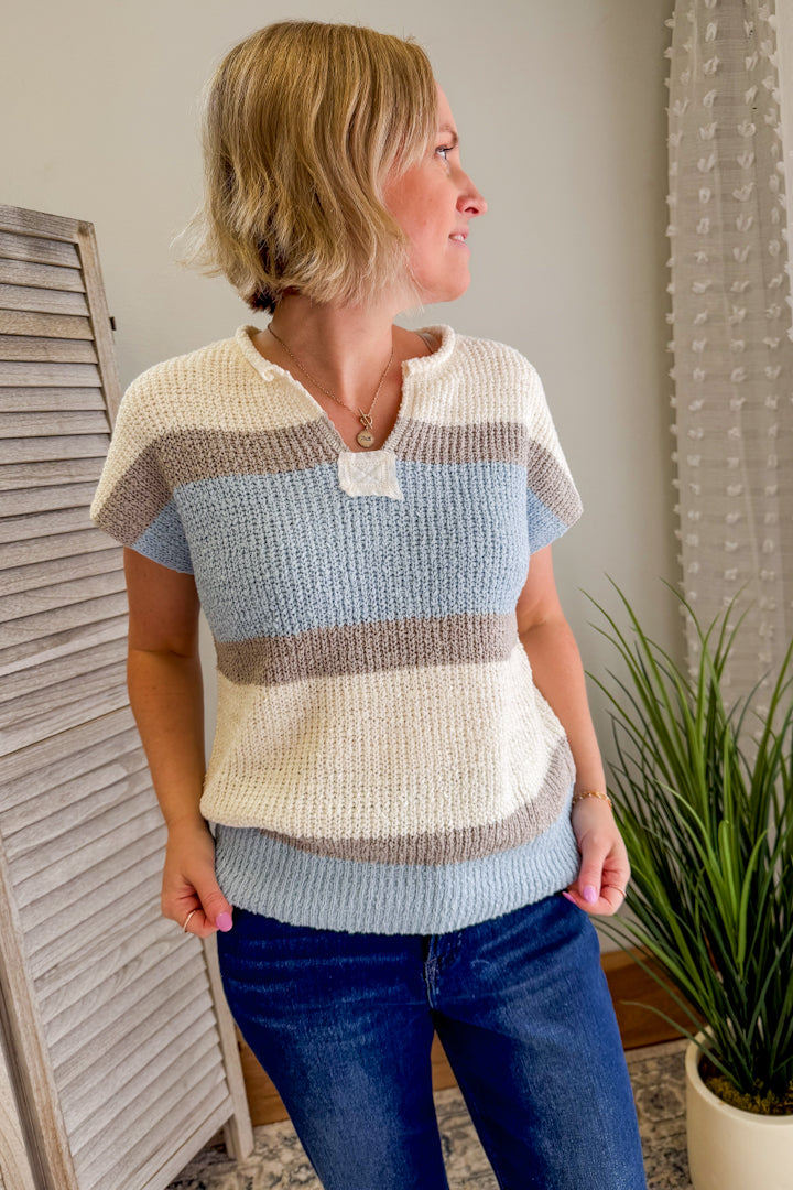Women's short sleeve knit sweater with color block details.