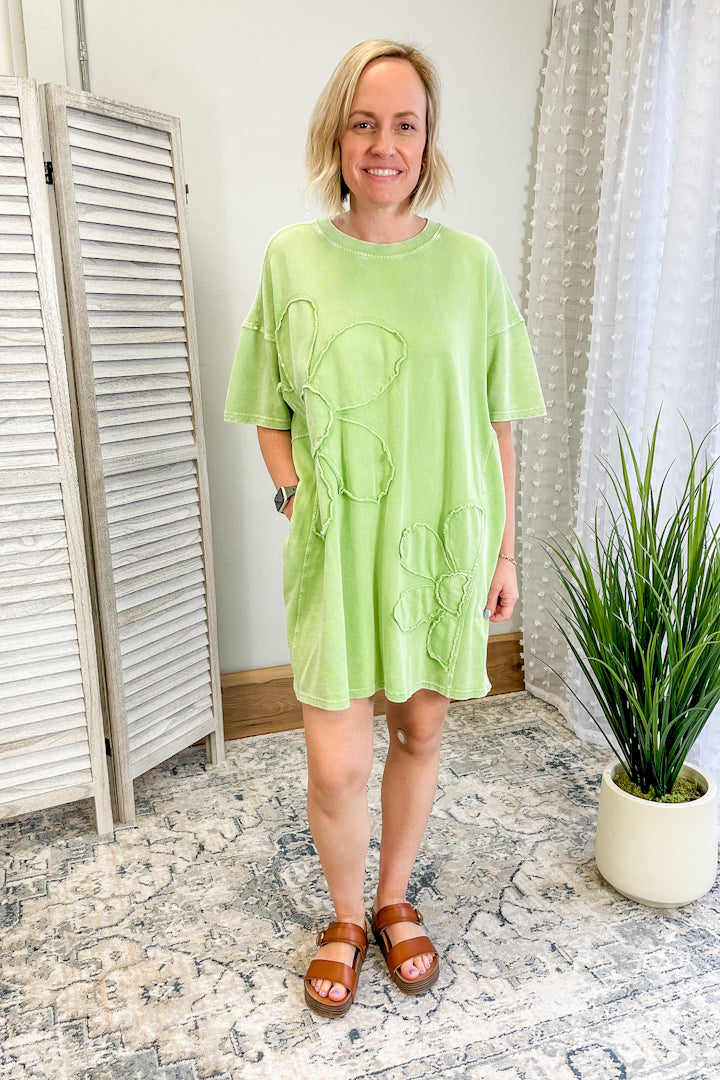 Women's relaxed-fitting tee shirt dress with daisy patch.