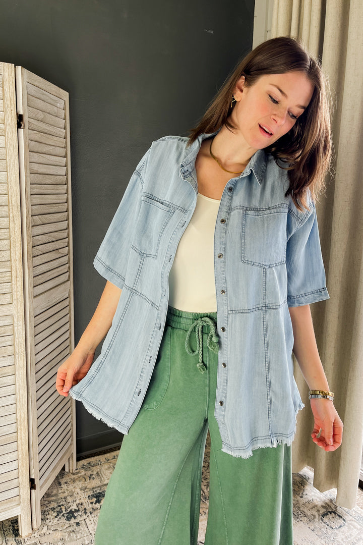 A light wash short sleeve button down denim top for women
