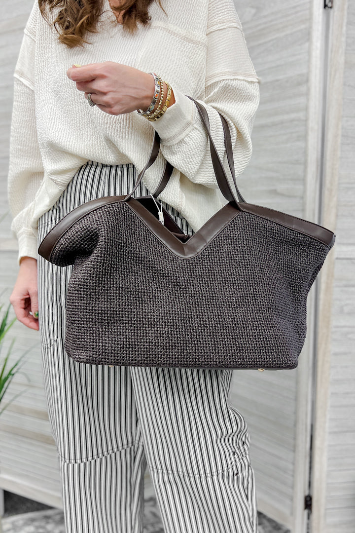 A chocolate brown dual top straps bag with a removable drawstring inside pouch