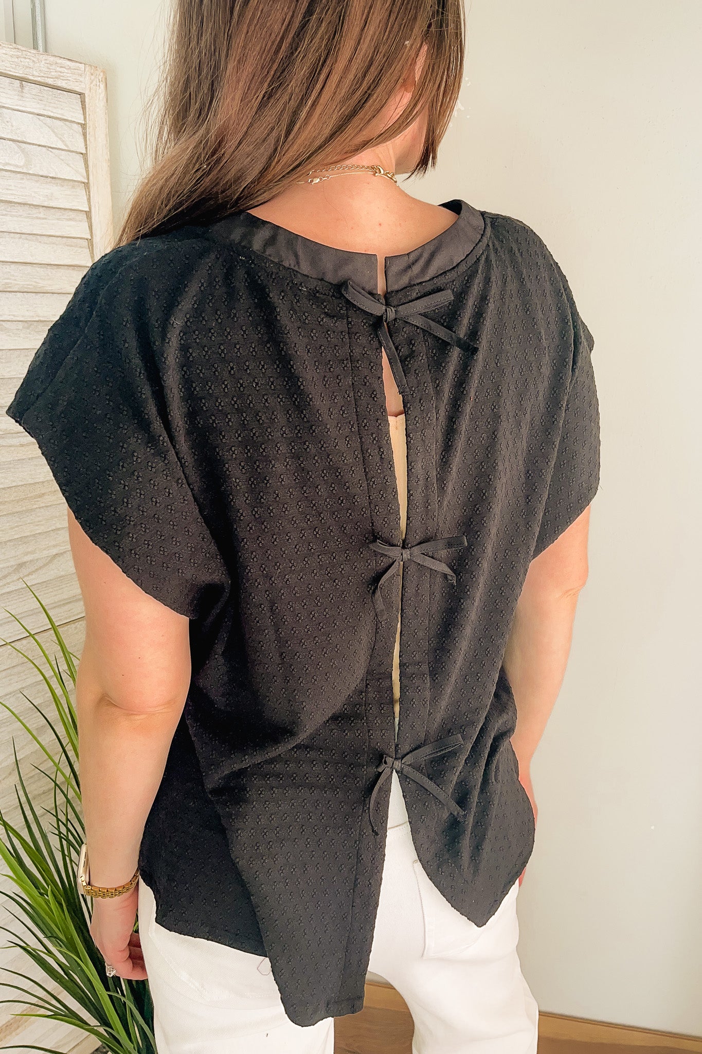 Women's open back sweater with bow tie details black