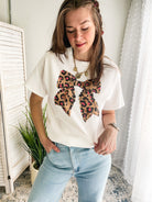 Women's oversized tee with leopard bow graphic.