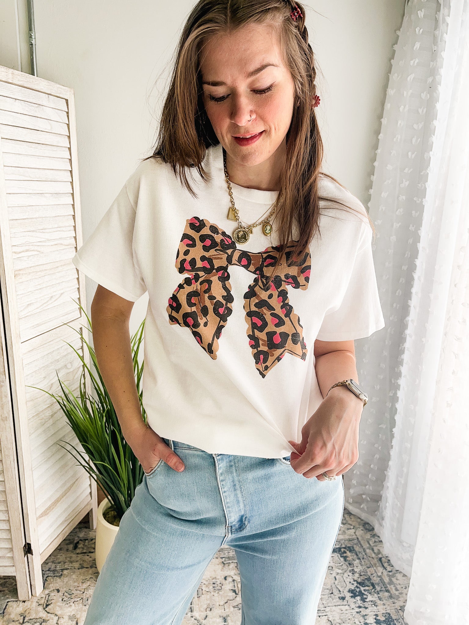 Women's oversized tee with leopard bow graphic.