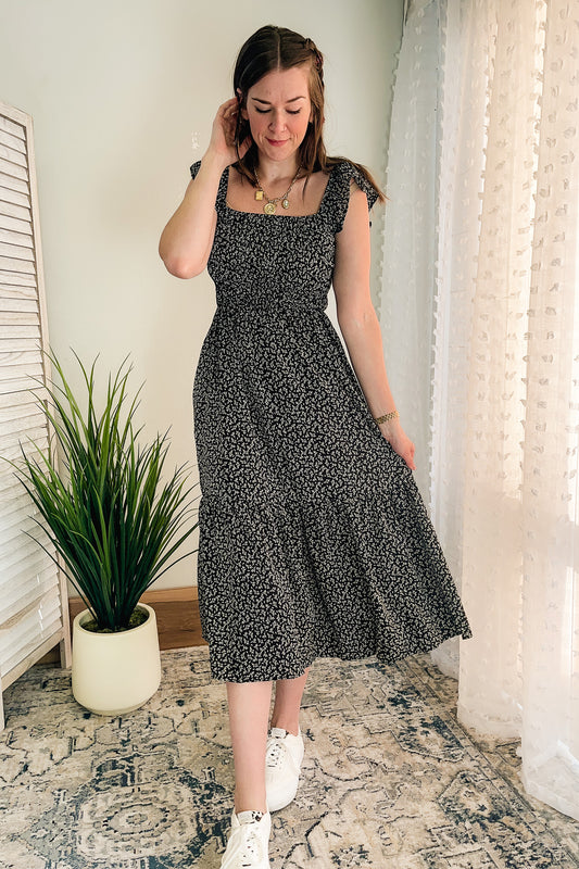 Women's smocked floral black dress with ruffle sleeves and pockets