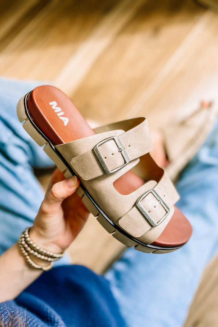 Buckle strap sandals with slight platform sole.