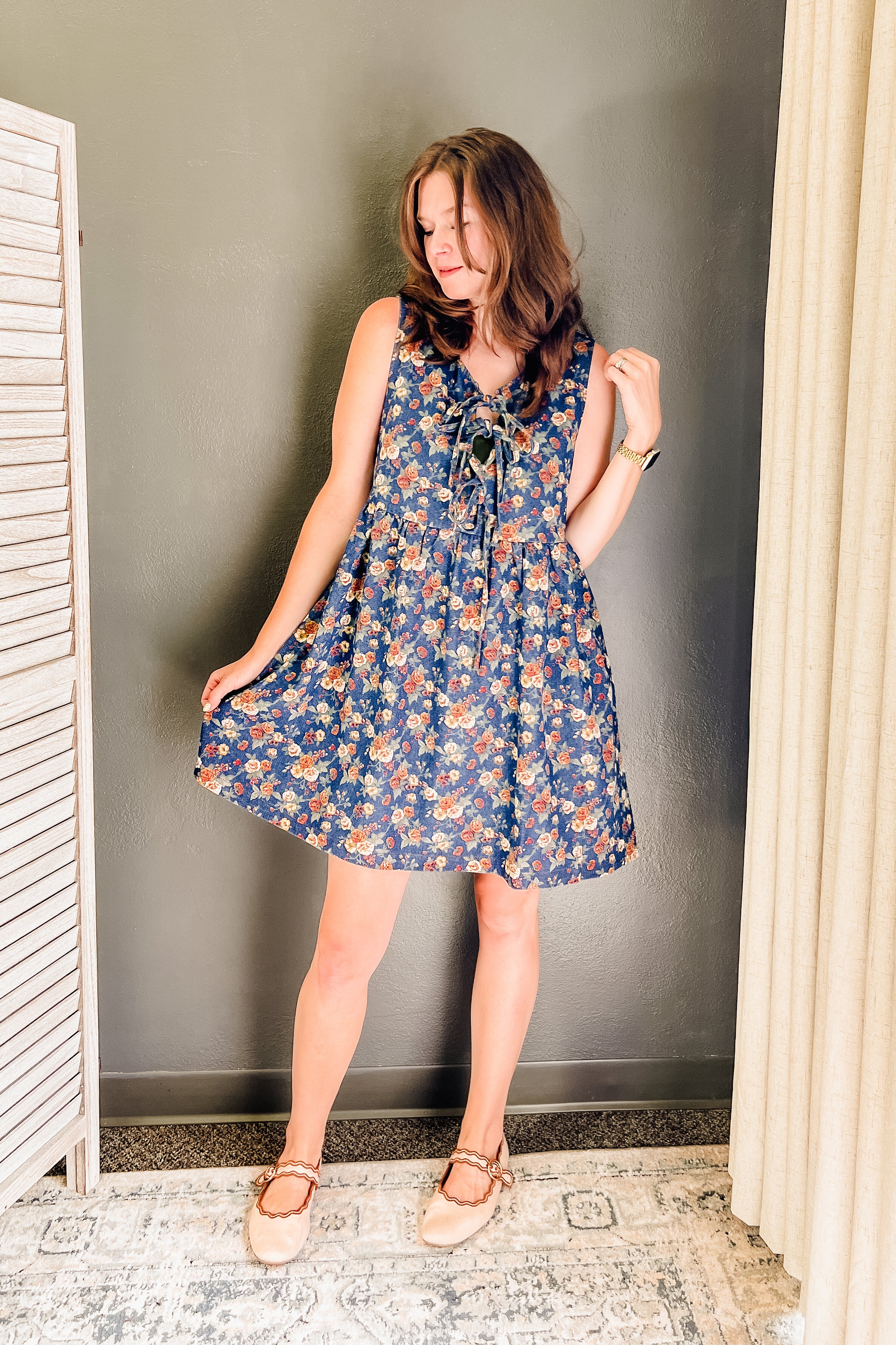 A tie front sleeveless mini length floral dark denim color dress for women.