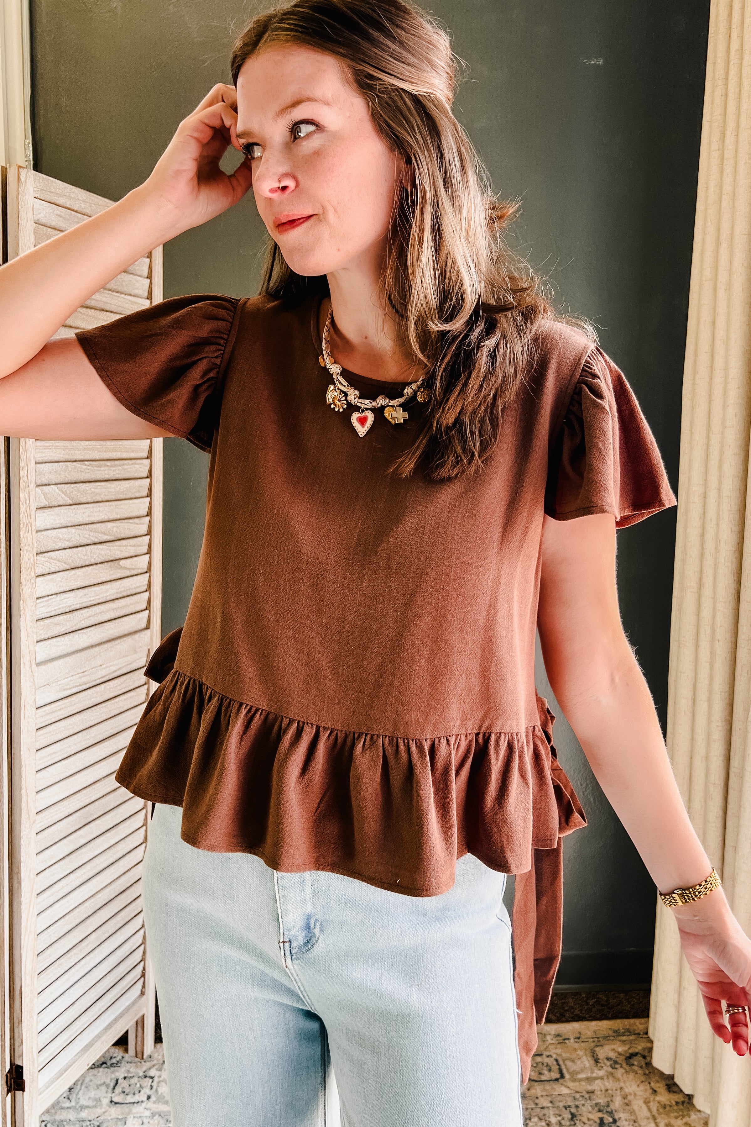 A scoop neck, flutter sleeve top with side ties with flowy ruffle bottom for women brown