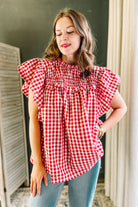 Gingham-print short sleeve blouse with ruffle sleeves.