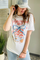 Women's relaxed-fitting tee with cowboy boot and bow graphic western america
