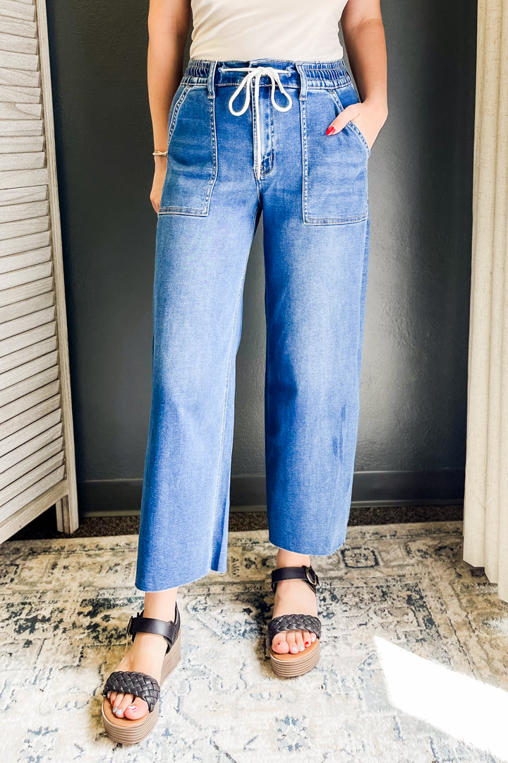 Soft, high-waisted wide leg denim with drawstring detail.