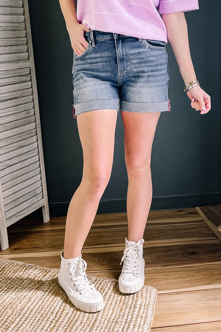 Mid-rise denim shorts with cuffs and ribbon detail.