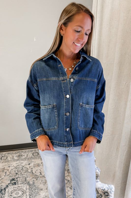 Women's medium wash denim jacket with button front and collar