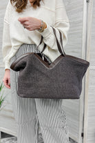 A chocolate brown dual top straps bag with a removable drawstring inside pouch 