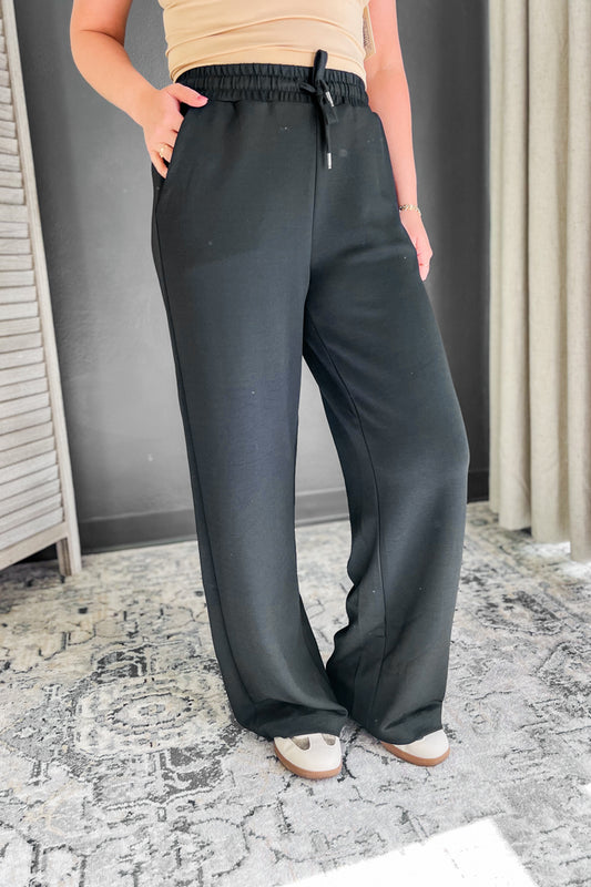 A black adjustable tie waistband pant for women